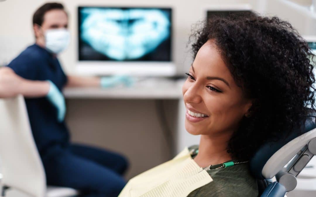 woman smiling during dental exam at bright dental studio